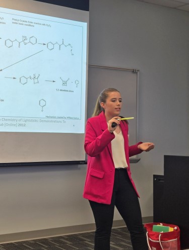 A student giving a slide presentation in class
