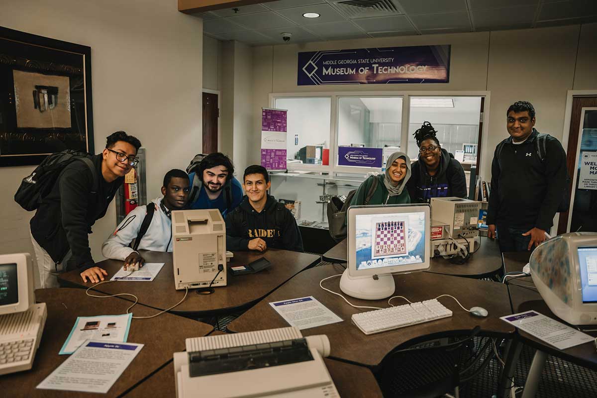 students surrounding vintage computers