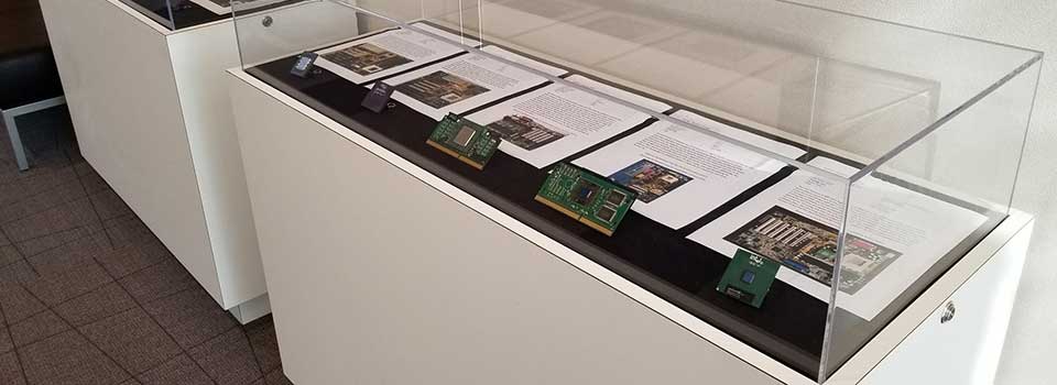 various motherboards and chips in a display case