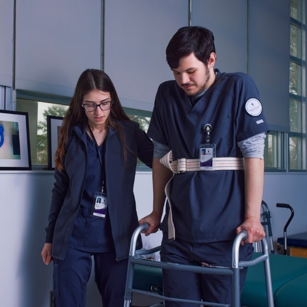 Two students simulating occupational therapy scenario with a walker