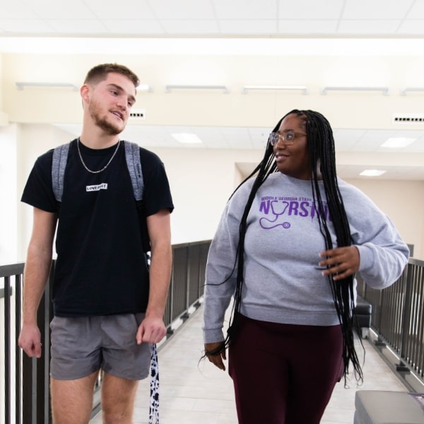 Two students chatting in the Oak Hall hallway