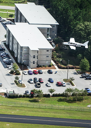 Areal photo of a plane flying by dorms at Eastman campus.