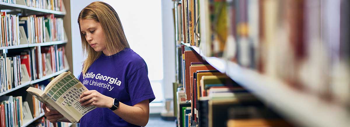 a student browses textbooks at the campus store