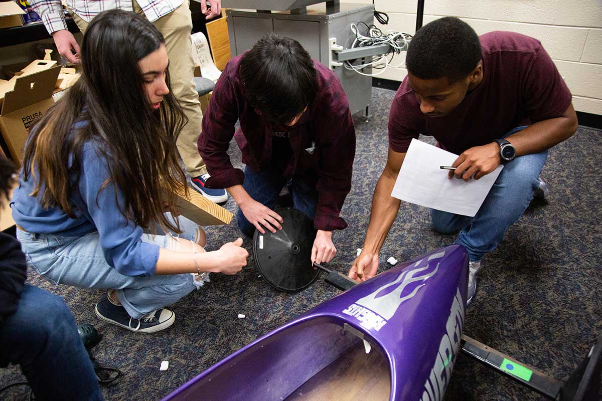 Students making a soapbox derby car.