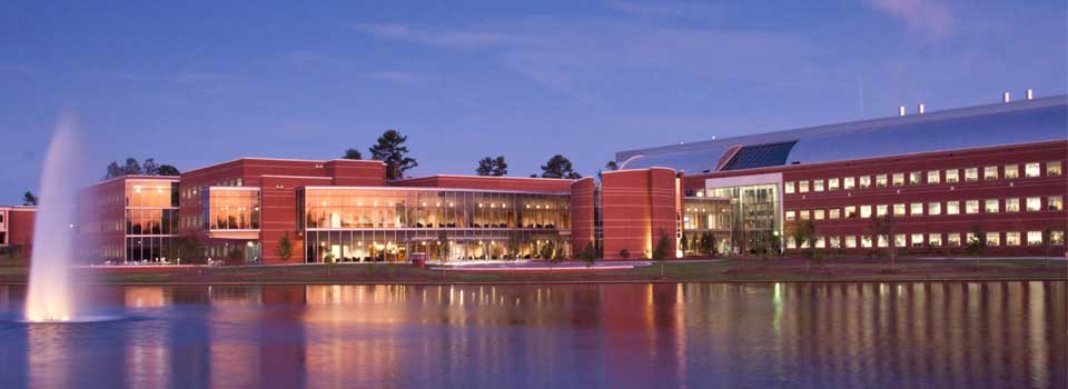 MGA lake and building at dusk.