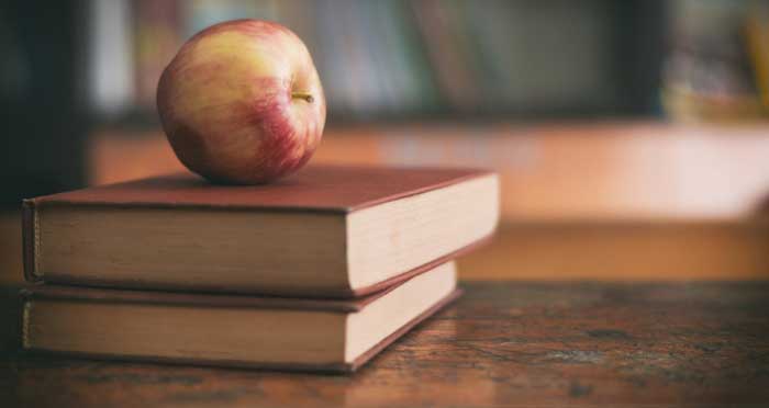 an apple on some books