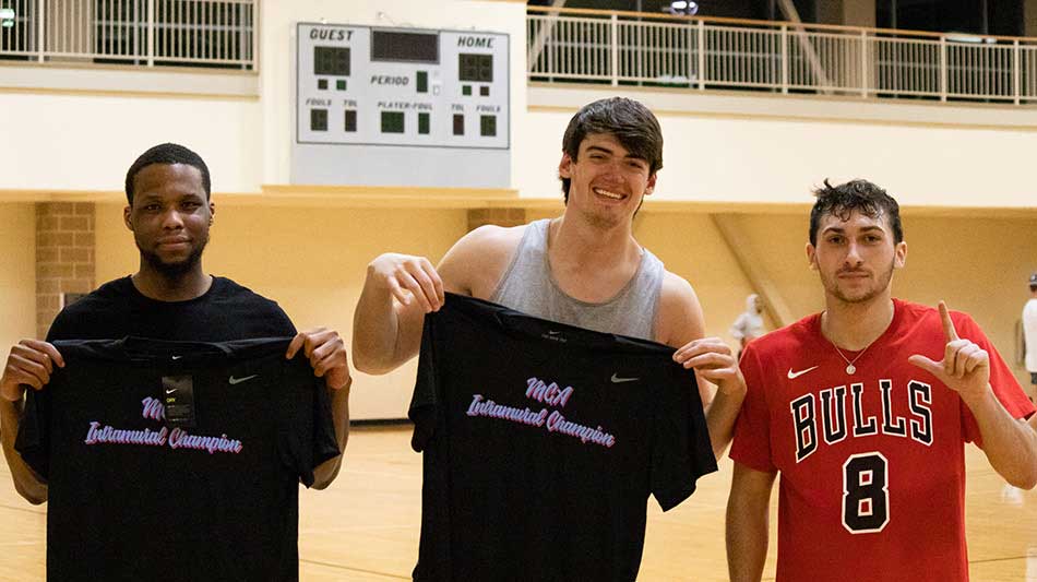 students holding jerseys after winning