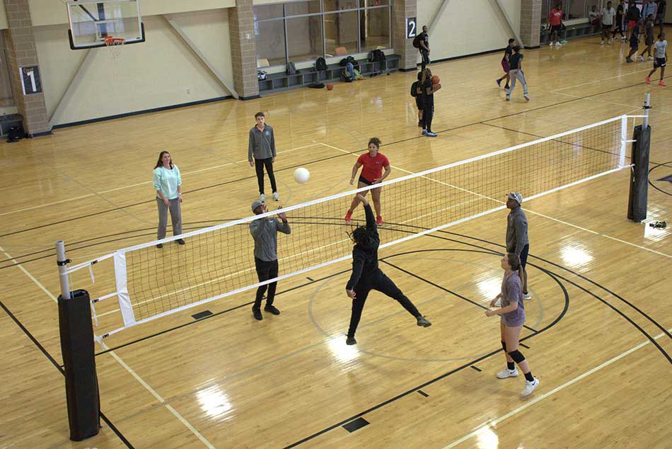 students playing indoor volleyball