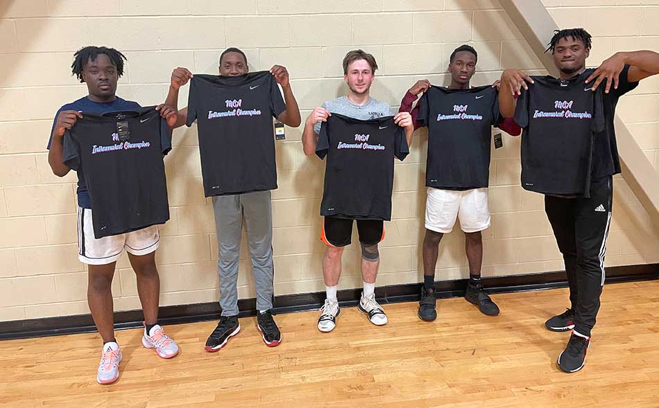 students holding up jerseys