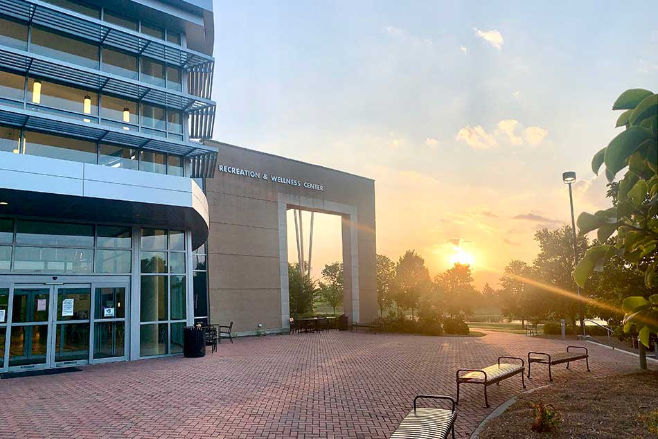 photo of the rec center with the sun going down behind it